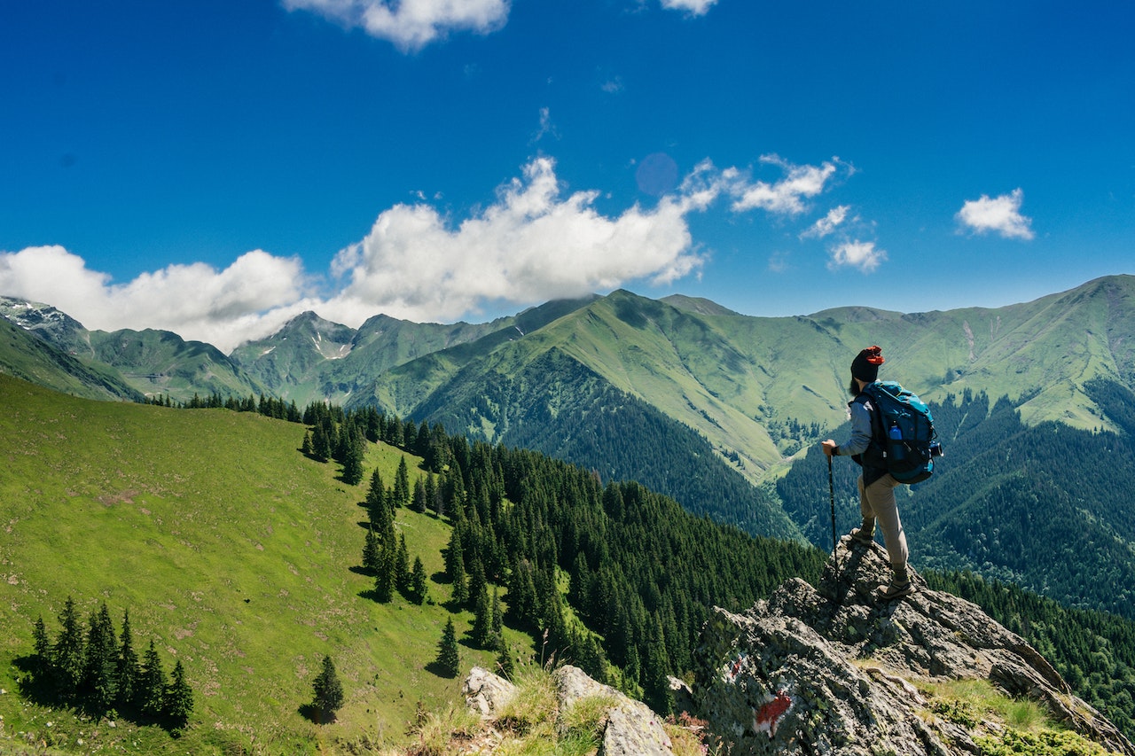 Man on top of a mountain peak